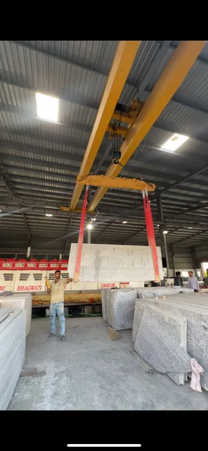 Gantry crane moving slabs inside the processing facility